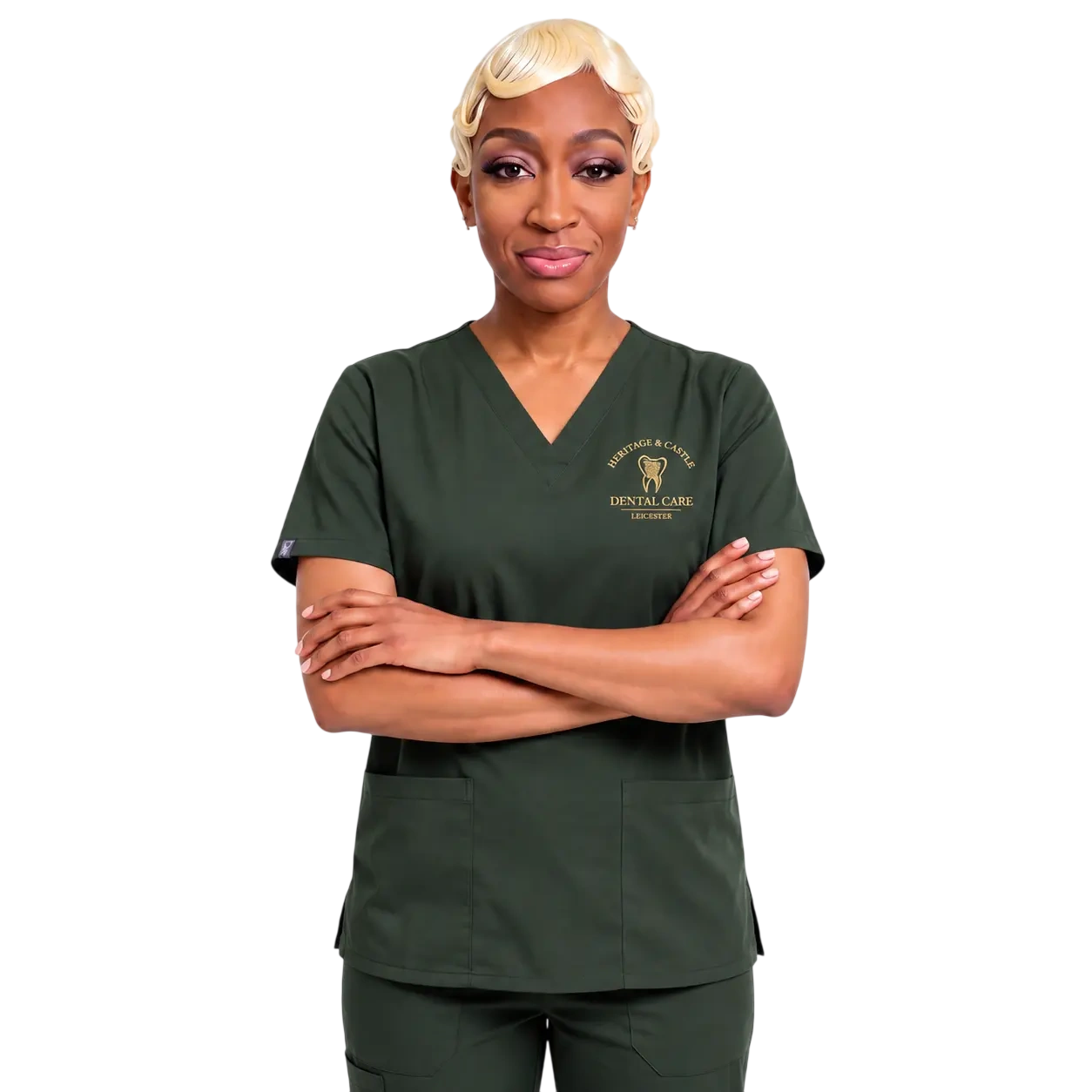 Female dental professional in green scrubs standing with arms crossed